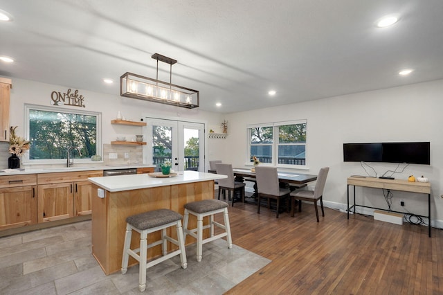 9247 State Highway 13, Kimberling City, MO 65686 - kitchen with a kitchen island, french doors, a kitchen bar, a sink, and light countertops