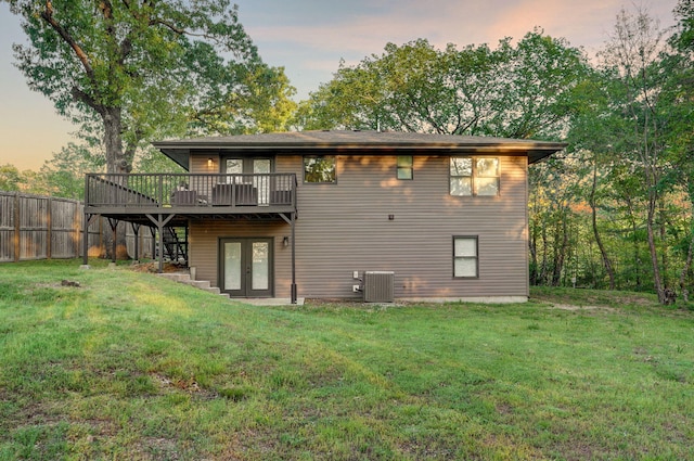 9247 State Highway 13, Kimberling City, MO 65686 - back of property at dusk featuring a yard, cooling unit, a wooden deck, and french doors