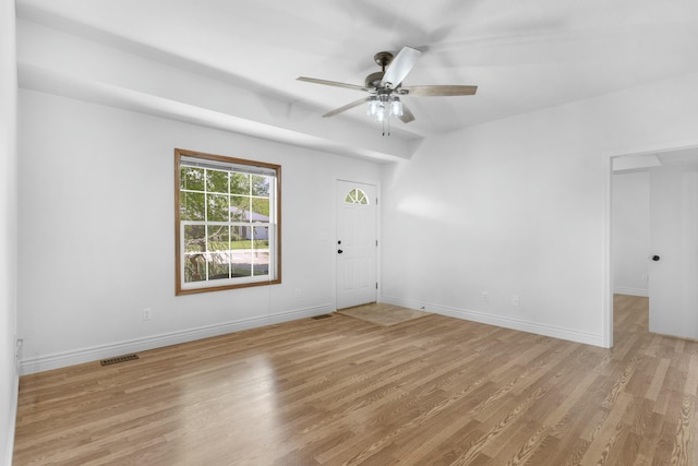 unfurnished room with baseboards, ceiling fan, light wood finished floors, and visible vents