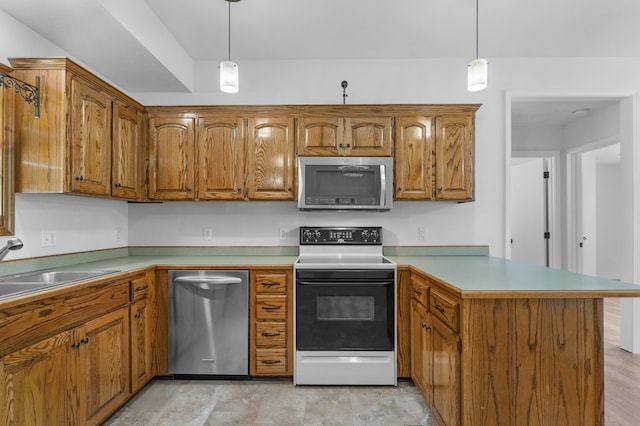 kitchen with brown cabinetry, decorative light fixtures, appliances with stainless steel finishes, a sink, and a peninsula