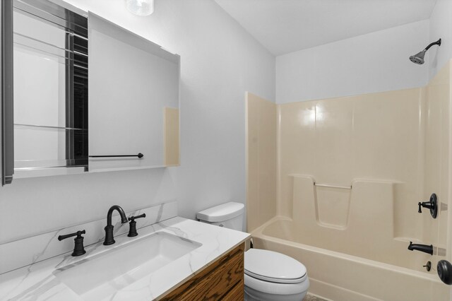 full bathroom with toilet, bathing tub / shower combination, and vanity