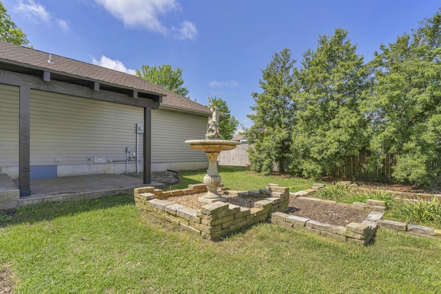 view of yard featuring fence and a patio