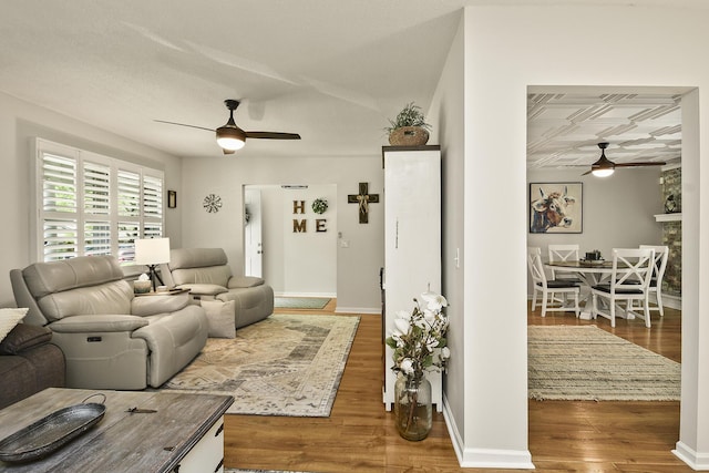 1522 S Oakland Ave, Bolivar, MO 65613 - living room with baseboards, a ceiling fan, and wood finished floors