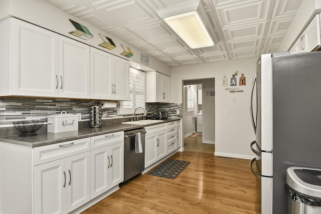 1522 S Oakland Ave, Bolivar, MO 65613 - kitchen featuring dark countertops, a sink, an ornate ceiling, stainless steel appliances, and backsplash