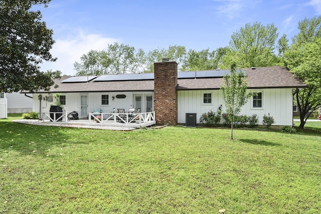 1522 S Oakland Ave, Bolivar, MO 65613 - rear view of house with a yard, central AC, a chimney, and a shingled roof