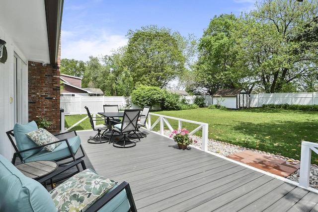 1522 S Oakland Ave, Bolivar, MO 65613 - wooden terrace with a fenced backyard, outdoor dining area, a yard, and a shed