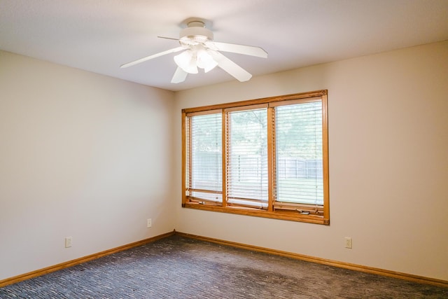 unfurnished room with baseboards, a ceiling fan, and carpet