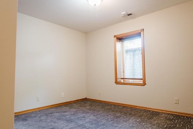 carpeted empty room with baseboards and visible vents