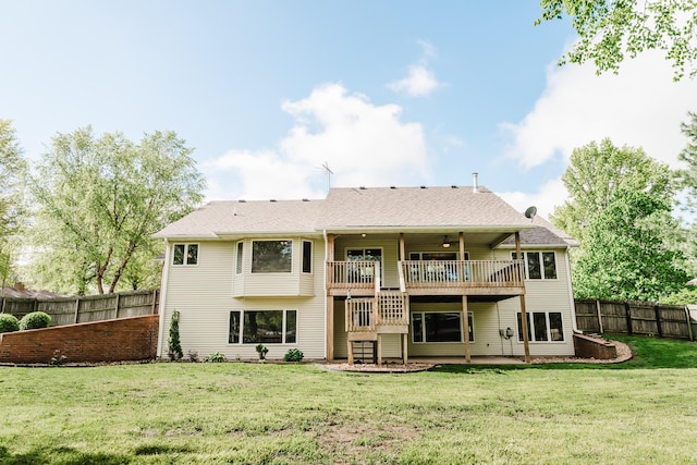 rear view of property with ceiling fan, a deck, a fenced backyard, stairs, and a lawn