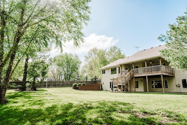 view of yard with stairs, a fenced backyard, ceiling fan, and a wooden deck