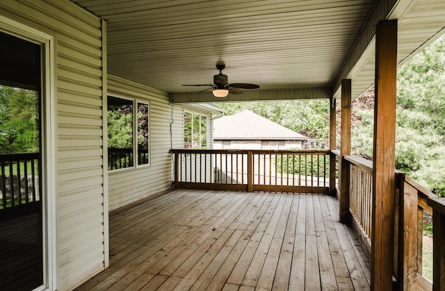 wooden terrace with a ceiling fan