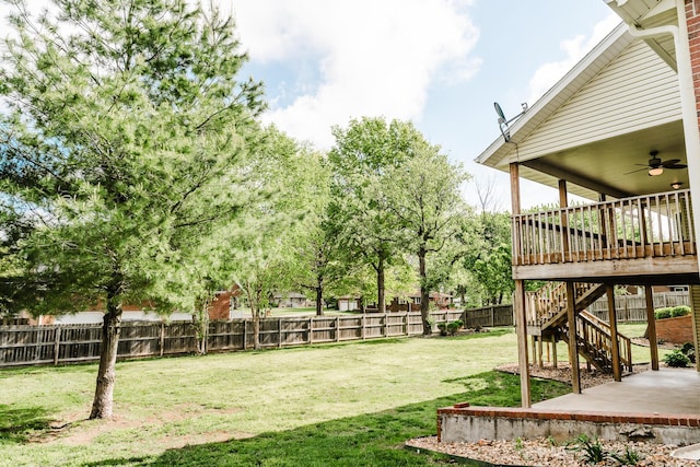 view of yard with stairway, ceiling fan, a fenced backyard, and a patio area