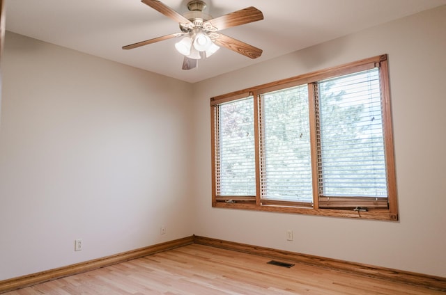empty room with a ceiling fan, baseboards, visible vents, and light wood-style flooring