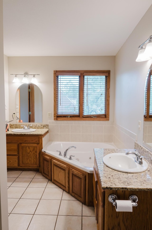 full bath with vanity, tile patterned flooring, and a whirlpool tub