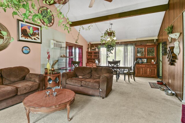 living room featuring a ceiling fan, wood walls, vaulted ceiling with beams, and carpet