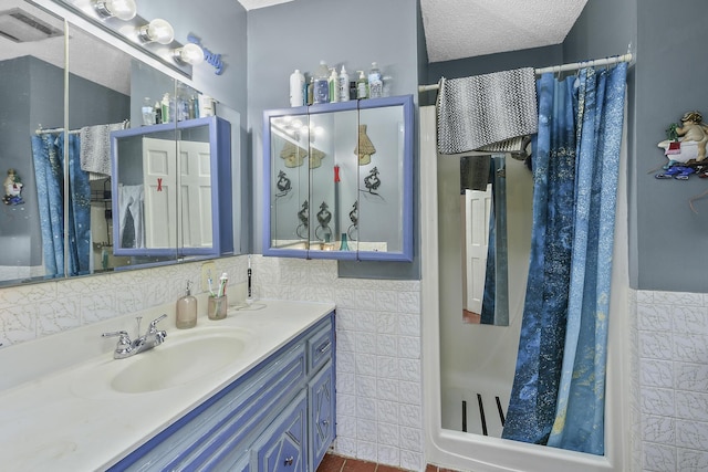bathroom featuring vanity, tile walls, wainscoting, and a shower with shower curtain