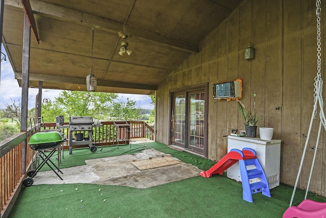 view of patio with a wall mounted AC and area for grilling