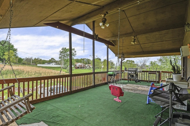 wooden terrace with a grill