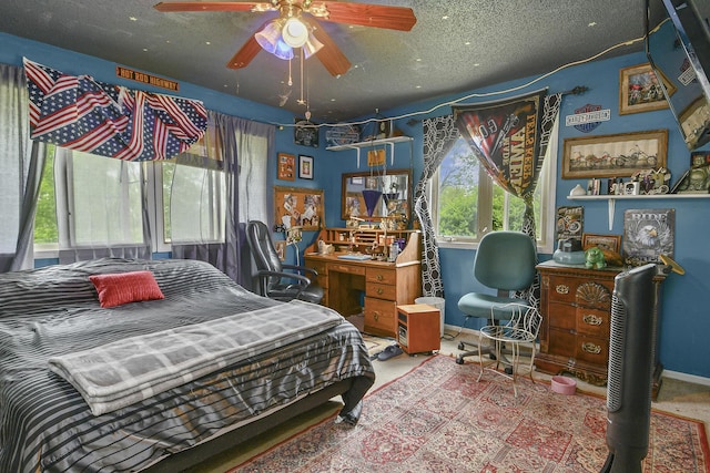 bedroom with baseboards and a textured ceiling