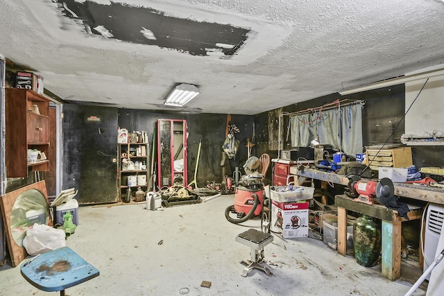miscellaneous room with concrete floors and a textured ceiling