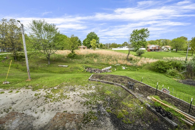 view of yard with fence and a rural view