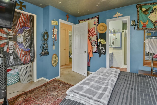 bedroom with baseboards, carpet flooring, and a textured ceiling