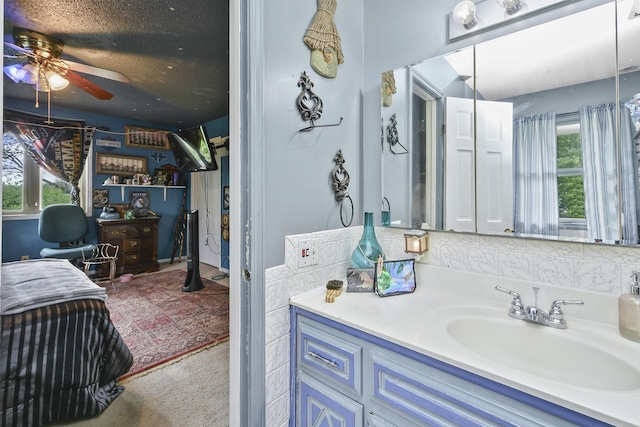 bathroom featuring vanity, plenty of natural light, and a ceiling fan