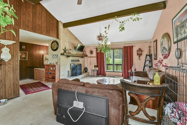 carpeted living room with vaulted ceiling with beams, a fireplace, and wood walls
