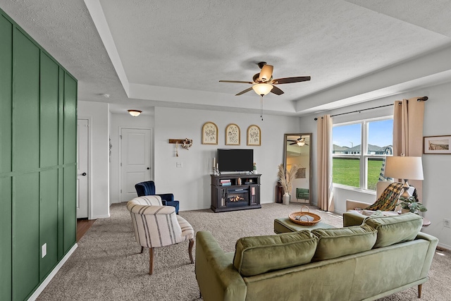1418 S Lorraine Ave, Republic, MO 65738 - living room with a raised ceiling, a textured ceiling, carpet, a ceiling fan, and baseboards