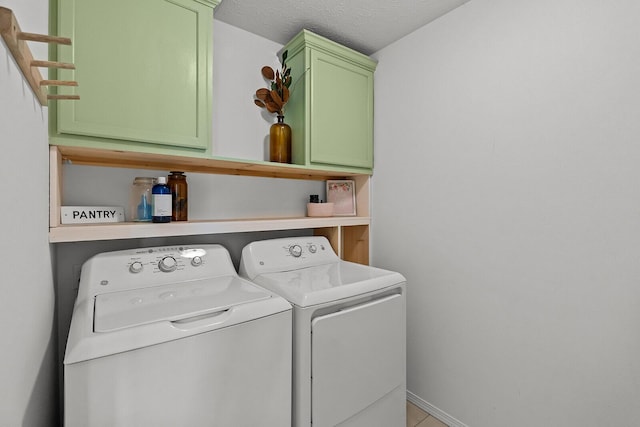 1418 S Lorraine Ave, Republic, MO 65738 - washroom with tile patterned flooring, washing machine and dryer, baseboards, a textured ceiling, and cabinet space