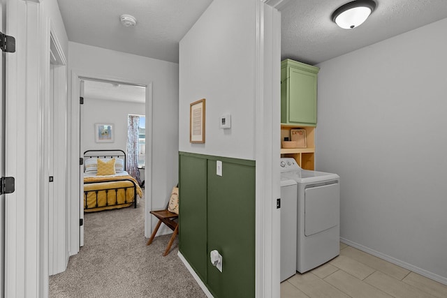 1418 S Lorraine Ave, Republic, MO 65738 - laundry area with baseboards, washer and clothes dryer, a textured ceiling, and cabinet space