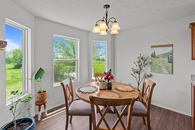 1418 S Lorraine Ave, Republic, MO 65738 - dining space featuring an inviting chandelier, baseboards, a textured ceiling, and light wood-style flooring