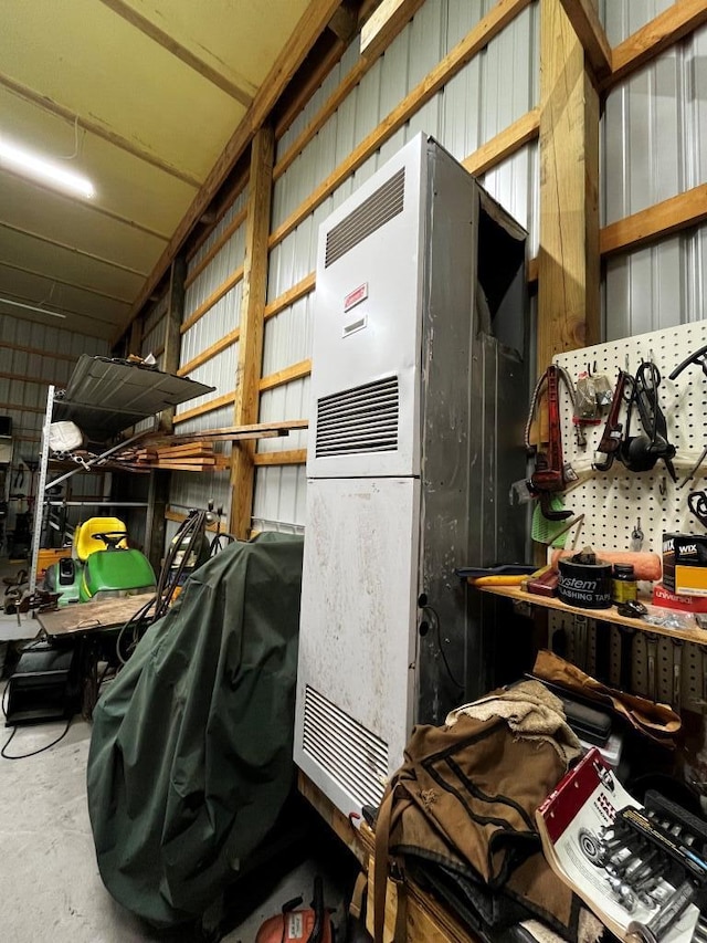 miscellaneous room featuring a workshop area and concrete floors