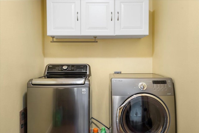laundry room featuring cabinet space and washing machine and dryer