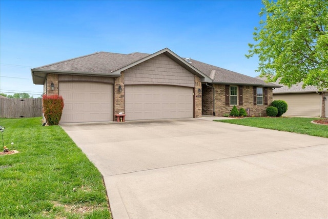 ranch-style house featuring fence, an attached garage, brick siding, a front yard, and driveway