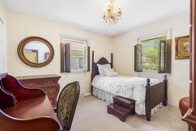 3660 S Ferguson Ave, Springfield, MO 65807 - carpeted bedroom featuring baseboards, a textured ceiling, and a chandelier
