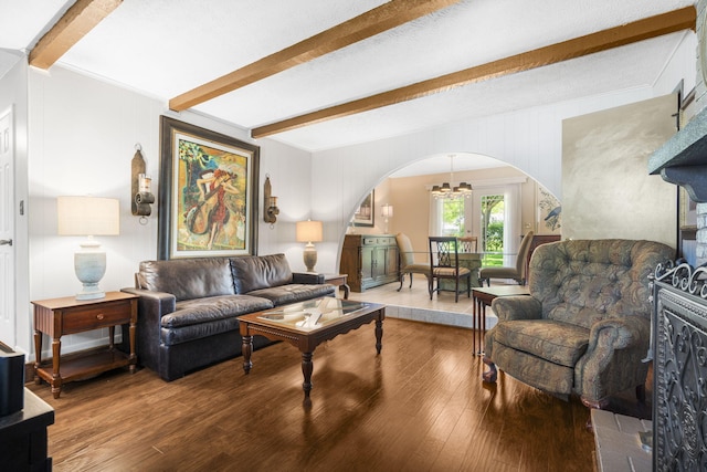 3660 S Ferguson Ave, Springfield, MO 65807 - living area with an inviting chandelier, arched walkways, beamed ceiling, and wood finished floors