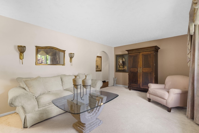 3660 S Ferguson Ave, Springfield, MO 65807 - living room with arched walkways, baseboards, and light colored carpet