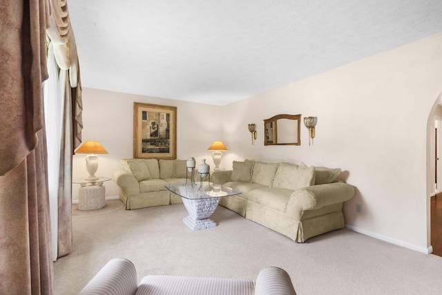 3660 S Ferguson Ave, Springfield, MO 65807 - carpeted living area featuring arched walkways and baseboards