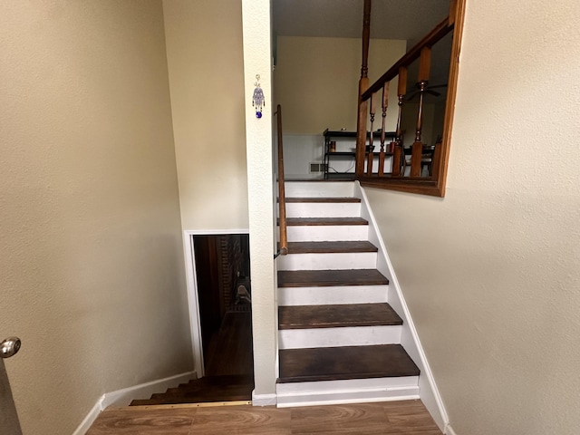 stairs with baseboards and wood finished floors