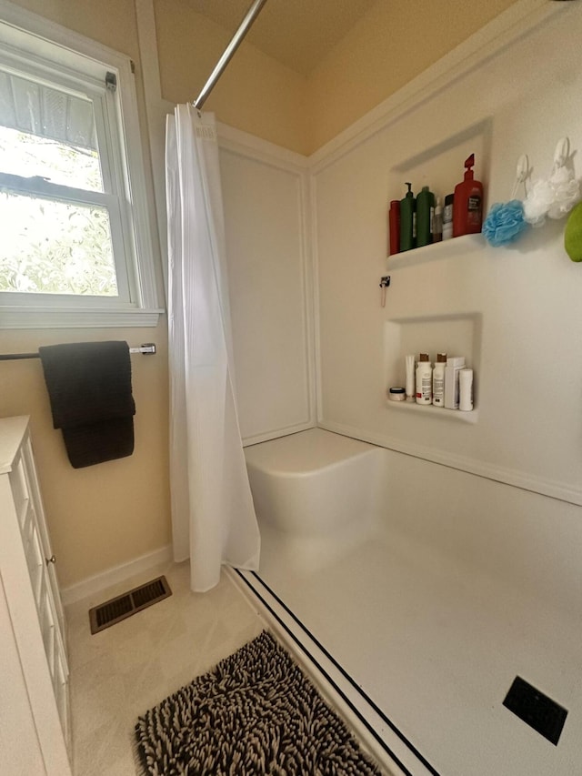full bathroom with a shower with curtain, baseboards, tile patterned floors, and visible vents