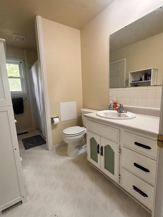 full bathroom with visible vents, a shower stall, vanity, tile patterned floors, and toilet