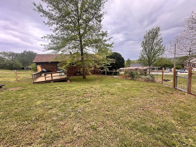 view of yard featuring fence and a wooden deck