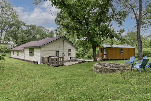 418 S 5th St, Branson, MO 65616 - back of property with a fire pit, a deck, a yard, and an outbuilding