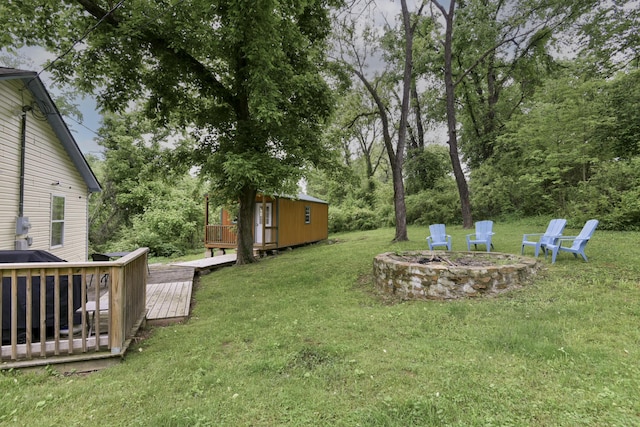 418 S 5th St, Branson, MO 65616 - view of green lawn with a wooden deck, a fire pit, and an outbuilding