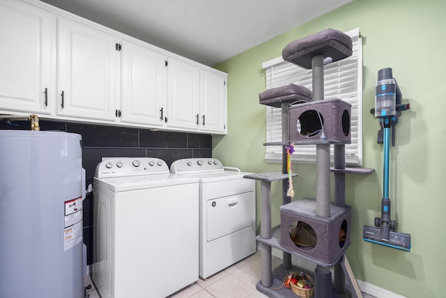 laundry area with cabinet space, light tile patterned floors, washer and clothes dryer, and water heater