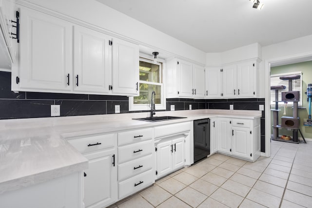kitchen featuring a sink, light tile patterned floors, light countertops, and dishwasher