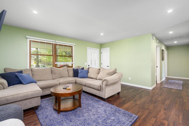 living room featuring recessed lighting, dark wood-style flooring, and baseboards