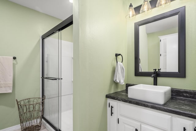 bathroom featuring vanity and a stall shower