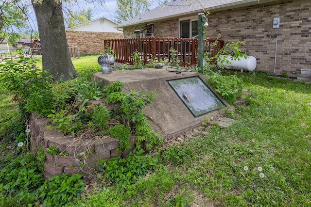 entry to storm shelter with a lawn and fence